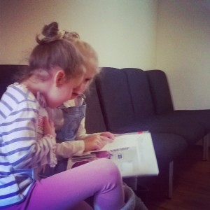 Day 237:  The girls love our twice-yearly trip to the dentist (mainly because they get stickers!).  Here are Mimi and Lola in the waiting room practising their reading.