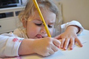 Day 274:  The look on my littlest daughter's face as she carefully concentrates on writing Christmas cards for her classmates at school