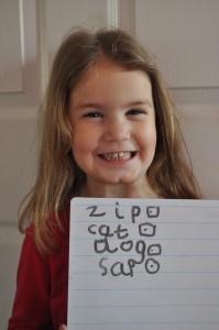 Day 334:  Lola took herself off with her whiteboard and pen and practised her writing.  She was so proud when she wrote 'zip', 'cat' and 'dog' all by herself :)