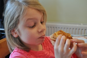 Day 340:  My brave girl trying something new for lunch (and loving the 'stretchy cheese') 