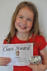 Day 436:  Lola came home from school with the Class Award trophy and certificate for her reading.  She was so proud!