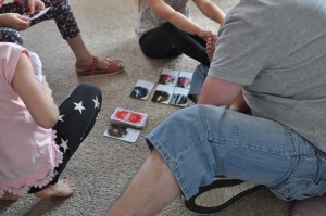 Day 550: Our last day together as a family before we're all back to work and school. I snuck this shot of my husband playing cards with the girls :)